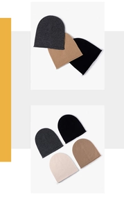 Detailed view of merino wool knitted beanies in neutral tones with soft rolled edges