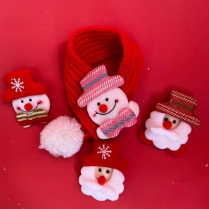 Detailed view of handmade knitted Christmas cat scarf with mini Santa and snowman patches