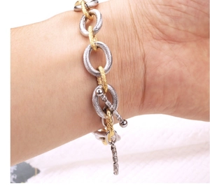 Chunky textured two-tone titanium steel bracelet with gold and silver links and OT toggle clasp