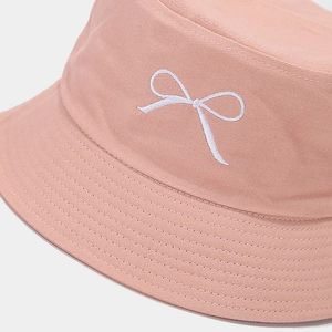 Pink canvas bucket hat with white bow embroidery in a minimalist Korean style for women