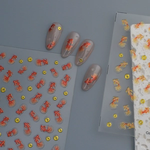 Detail of 3D koi fish nail stickers with red and gold glitter carp designs on nails