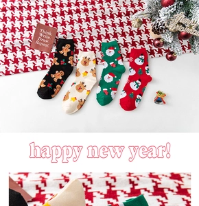 Detail of four Christmas socks featuring ginger man, reindeer, Santa, and snowman patterns