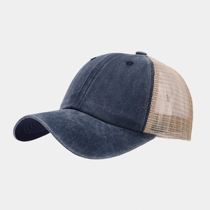 Detail view of washed navy cotton and khaki mesh patchwork on breathable baseball cap