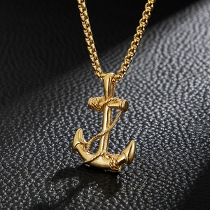 Close-up of gold stainless steel anchor pendant with rope detail on black leather
