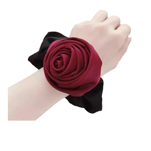 Elegant oversized dark red silk rose hair tie and wristband on female model wrist
