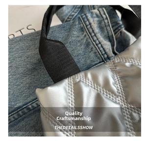 Close-up of silver quilted tote bag with diamond stitching and black ribbon handles
