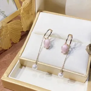 Pink tulip tassel earrings with pearls and gold chain presented in a luxury jewelry box