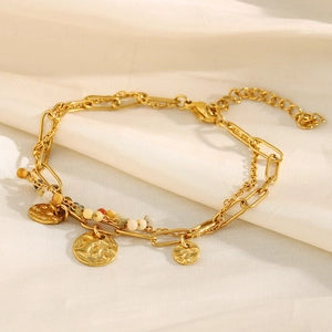 Close-up of double layer 18K gold plated bracelet with coin pendant and colorful beads