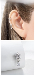 Detail of star-shaped ear stud with pavé cubic zirconia and a pear-cut drop pendant
