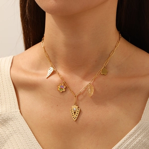 Gold-plated stainless steel paperclip chain necklace with arrow and flower charms on model