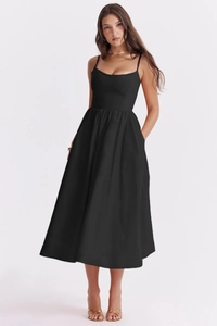 Detail view of the sleek backless design and flowy midi hem on the black summer dress