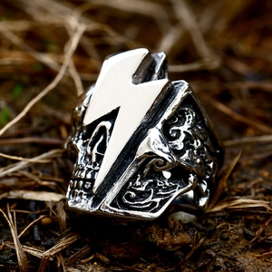 Detailed macro view of vintage stainless steel skull ring with lightning bolt emblem