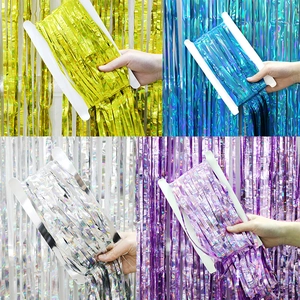 Metallic tinsel foil fringe curtain in gold, blue, silver, and purple for party backdrop