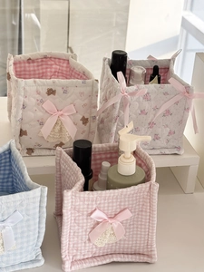 Pastel quilted fabric desktop storage baskets with floral patterns and lace bows
