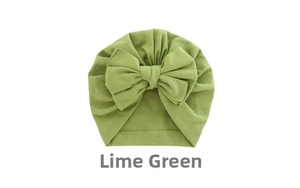Detail of baby turban hat in fruit green featuring a large soft knit double bow design