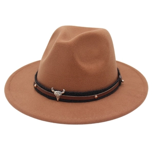 Close-up of brown wool fedora with a silver bull skull emblem and studded leather band