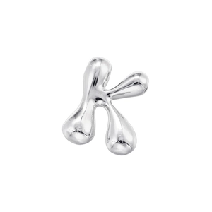 Macro shot of polished silver liquid metal letter K pendant with smooth reflective finish