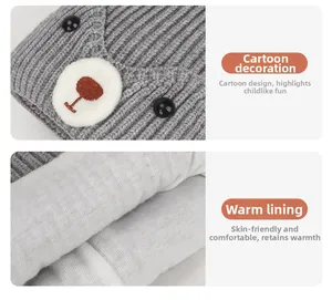 Detail of warm baby knit hat featuring cartoon bear decor and soft fleece lining