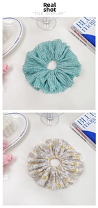 Detail of oversized floral and striped scrunchies showing soft chiffon fabric texture
