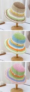 Detail of colorful hand-woven straw bucket hats featuring wavy hollow knit patterns