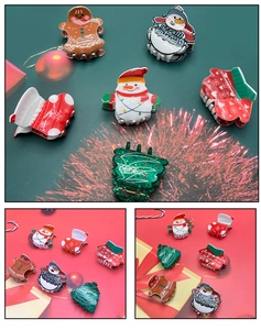 Detail of 6-piece Christmas hair claw set with gingerbread man and Santa Claus shapes