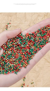 Christmas nail art jewelry set with colorful beads and metal studs held in hand