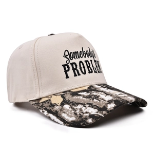 Detail of Somebody's Problem trucker hat with beige crown and camo visor embroidery