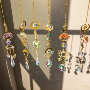 Golden Tree of Life crystal suncatchers with prisms creating rainbow light reflections