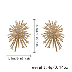 Detail view of gold starburst tassel earrings with sparkling clear cubic zirconia stones