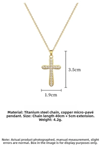 Detailed view of gold cross pendant with dimensions 3.5cm by 1.9cm and cubic zirconia inlay