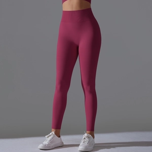 Macro detail of high-waisted seamless ribbed waistband on dark pink yoga leggings