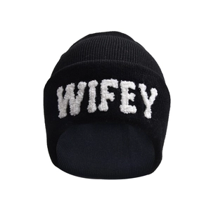 Detailed close-up of white 3D textured WIFEY embroidery on a black knitted beanie