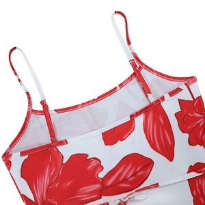 Detailed view of red floral print on white fabric with thin shoulder strap stitching
