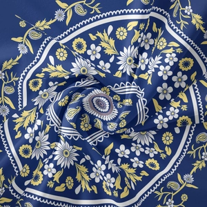 Macro view of blue mandala tapestry fabric showing detailed paisley floral patterns