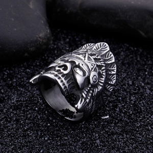 Macro shot of retro stainless steel men's ring with detailed skull and feather crown
