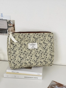 Dettaglio macro della borsa floreale in velluto a coste verde menta con zip a fiocco