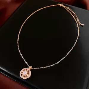 Gold plated circular necklace with zircon starburst pendant and adjustable lobster clasp