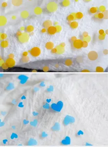 Detail of semi-transparent nail stickers with colorful polka dots and blue heart designs