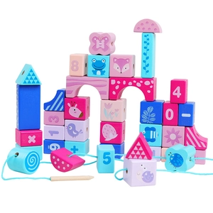 Detail of wooden threading blocks with animal prints, numbers, and colorful geometric shapes