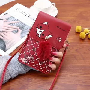 Detail of red leather mini shoulder bag with cartoon fox motif and heart pattern