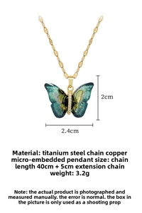 Detail of colorful butterfly pendant with dimensions 2.4x2cm and gold titanium chain
