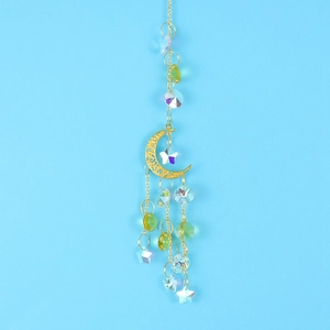 Detail view of golden crescent moon suncatcher with hanging crystals and star charms