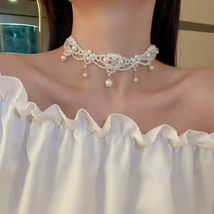 Detailed view of lace-style pearl choker necklace with flower motif and drop pearls