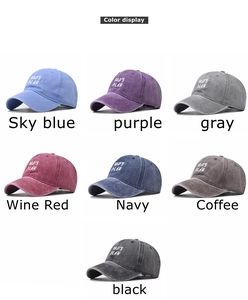 Matrix display of washed cotton baseball caps in seven colors with GOD'S PLAN embroidery
