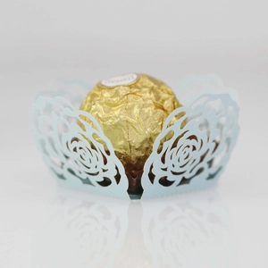 Macro detail of laser-cut light blue rose hollow paper candy box for wedding decor