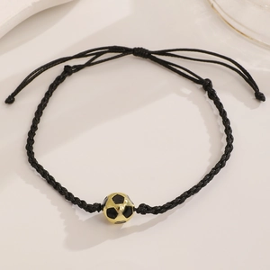 Detail of adjustable black braided soccer bracelet with a gold and black metal bead