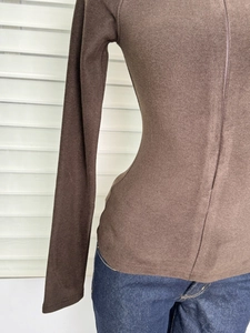 Close-up of coffee brown slim-fit thermal top with soft brushed fleece texture detail