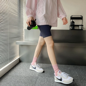 Pink cotton hollow-out crew socks for women styled with casual athletic wear and sneakers