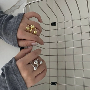 Three-ball gold plated brass open rings in gold and silver finish shown on hand