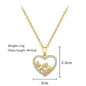 Close-up of a gold heart pendant necklace with rhinestones and size dimensions